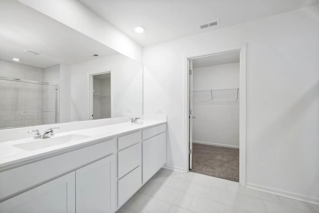 bathroom featuring vanity and a shower with shower door