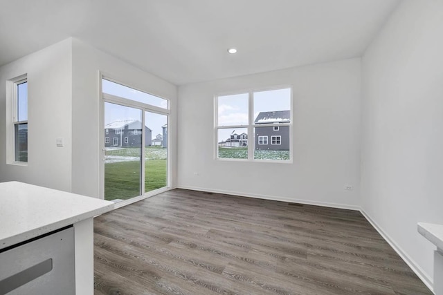 unfurnished dining area with dark hardwood / wood-style floors