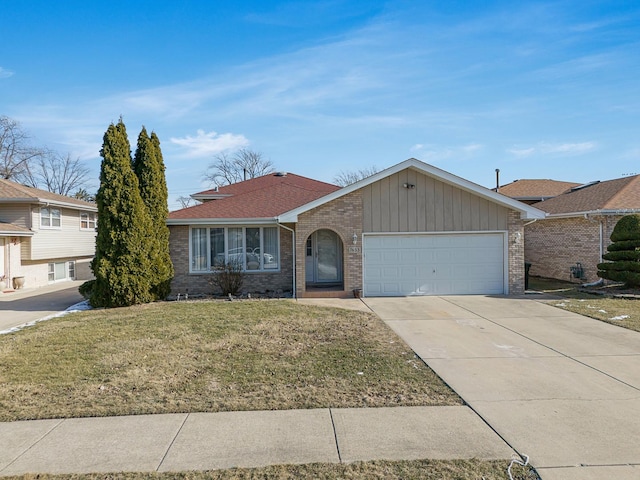 view of front facade featuring a front yard, concrete driveway, and brick siding