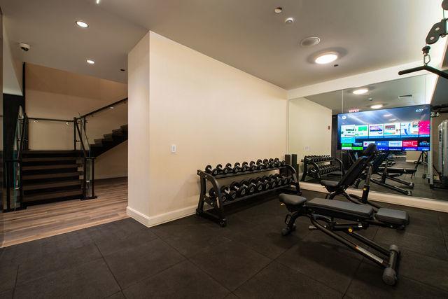 exercise room featuring dark wood-type flooring