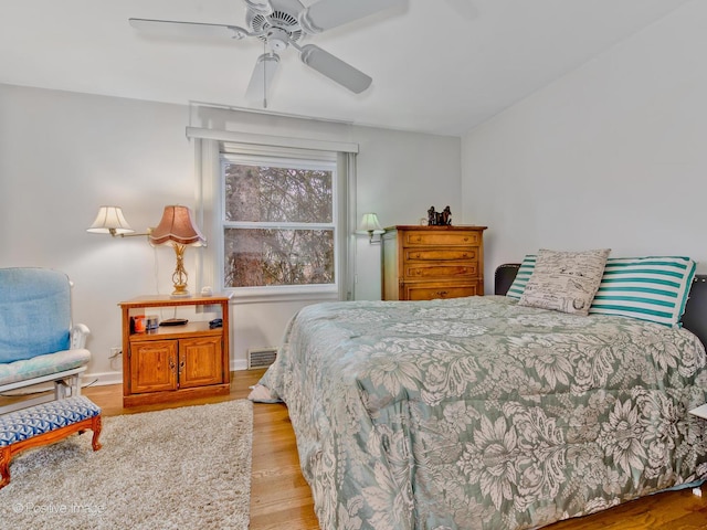 bedroom with ceiling fan and light hardwood / wood-style floors