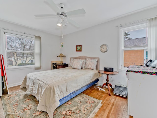 bedroom with light hardwood / wood-style flooring and ceiling fan