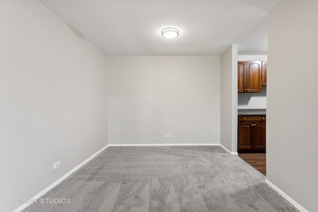 empty room with dark colored carpet