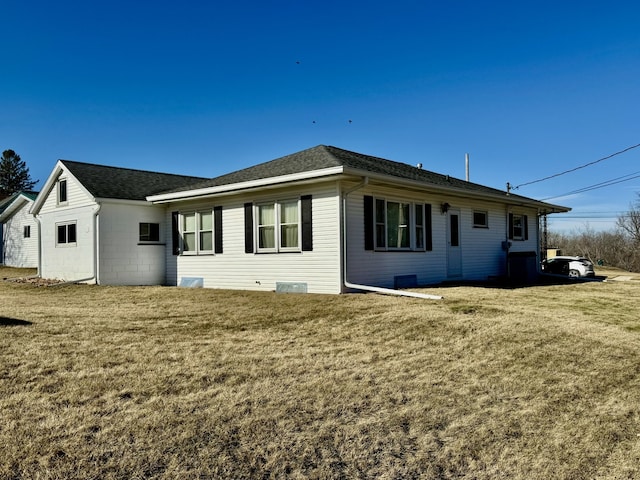 back of house with a lawn