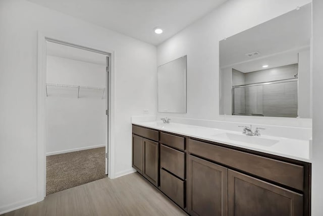 bathroom featuring an enclosed shower and vanity