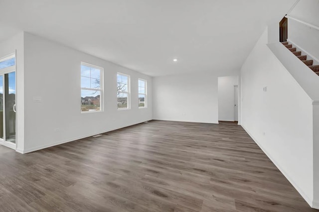 unfurnished living room featuring dark hardwood / wood-style flooring