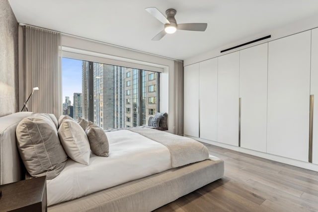 bedroom featuring light hardwood / wood-style flooring and ceiling fan