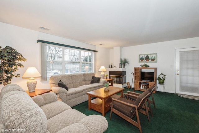 carpeted living room featuring a multi sided fireplace