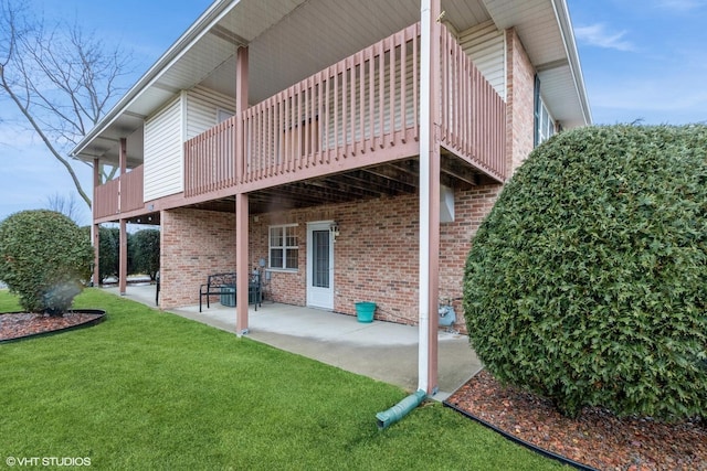 rear view of house with a lawn and a patio area