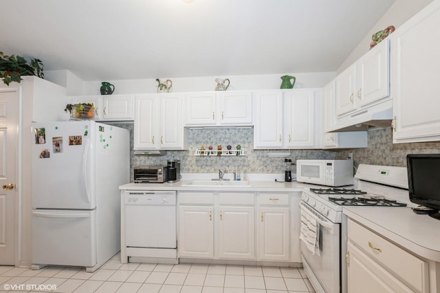 kitchen featuring sink, white cabinetry, light tile patterned floors, white appliances, and decorative backsplash