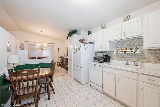 kitchen featuring hanging light fixtures, white cabinetry, sink, and white appliances