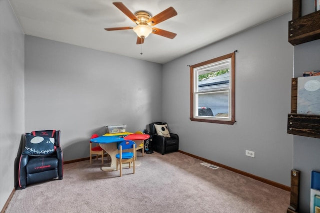 playroom featuring carpet floors, a ceiling fan, and baseboards