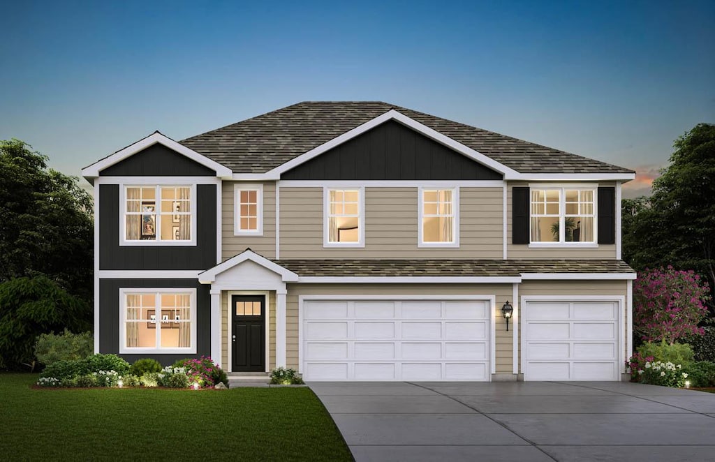 view of front of house featuring a garage and a yard