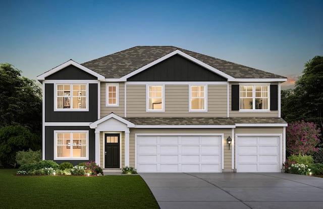 view of front of house featuring a garage and a yard