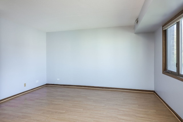 spare room with light hardwood / wood-style flooring