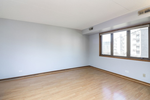 spare room with light hardwood / wood-style flooring