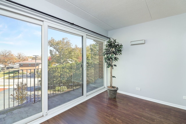 unfurnished room featuring dark hardwood / wood-style floors and a textured ceiling