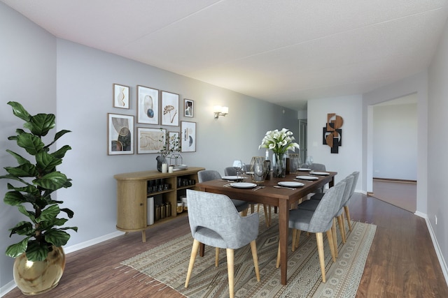 dining space with dark hardwood / wood-style floors