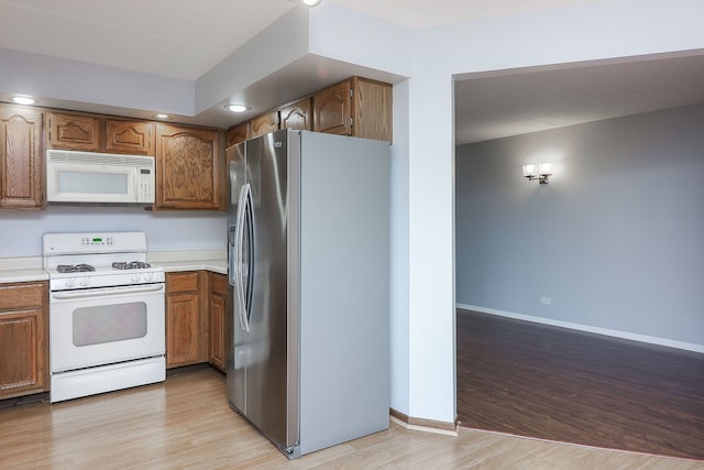 kitchen featuring white appliances and light wood-type flooring