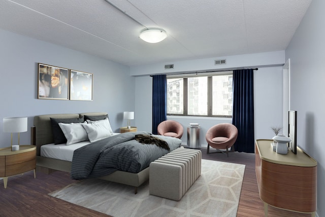 bedroom featuring hardwood / wood-style floors and a textured ceiling