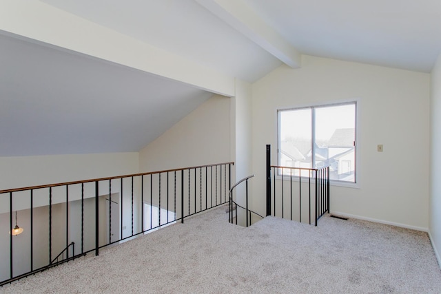 additional living space with vaulted ceiling with beams and light colored carpet