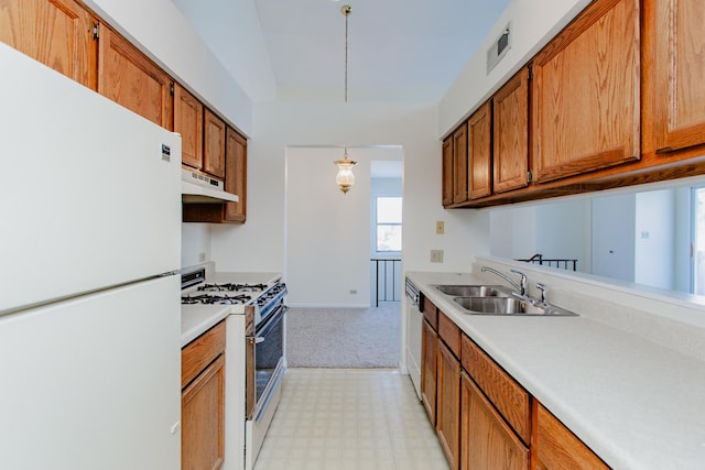 kitchen featuring stainless steel appliances, sink, and decorative light fixtures