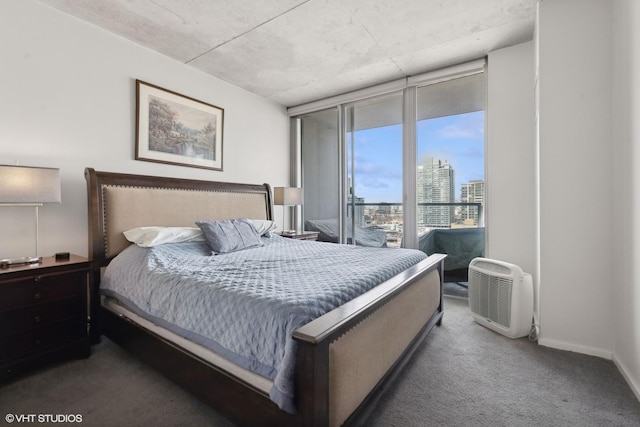 carpeted bedroom with access to outside and a wall of windows