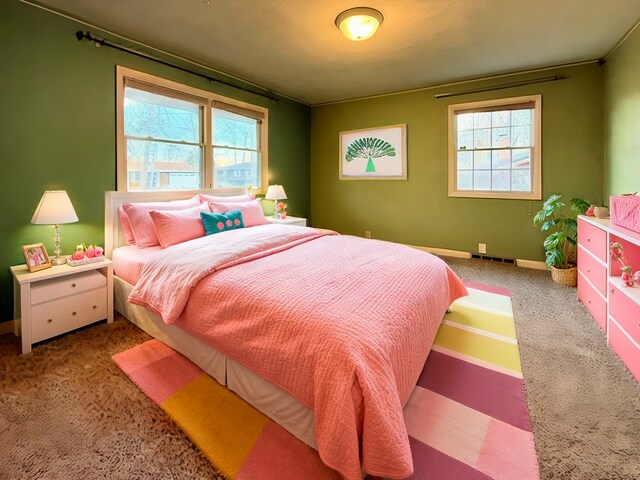 bedroom with visible vents, multiple windows, and baseboards