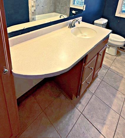 bathroom featuring tile patterned flooring, toilet, and vanity