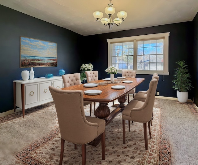 dining area with baseboards, light colored carpet, and a chandelier