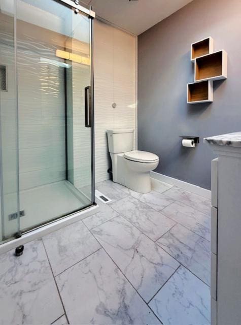 full bathroom featuring toilet, marble finish floor, a shower stall, baseboards, and vanity