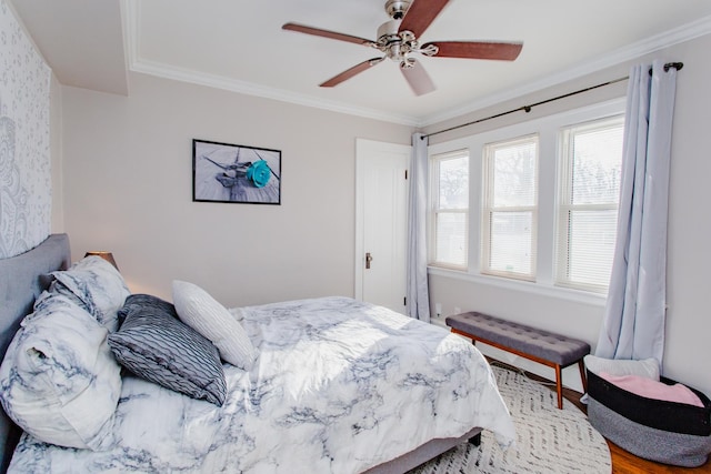 bedroom featuring ceiling fan, ornamental molding, and wood-type flooring