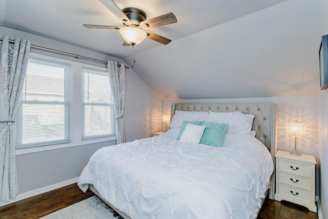 bedroom with vaulted ceiling, dark hardwood / wood-style floors, and ceiling fan