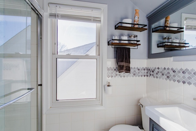 bathroom with an enclosed shower, tile walls, and a wealth of natural light