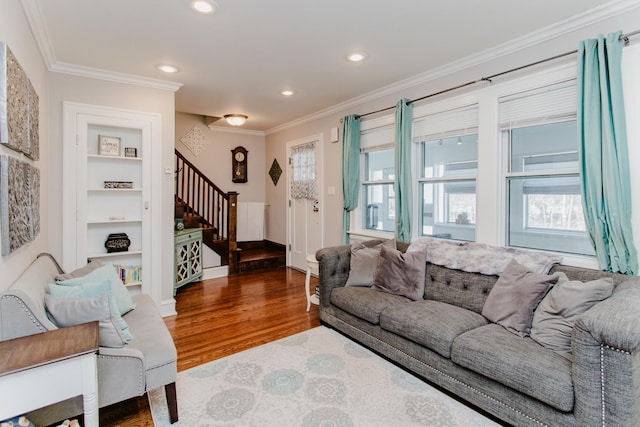 living room with built in shelves, dark wood-type flooring, and ornamental molding