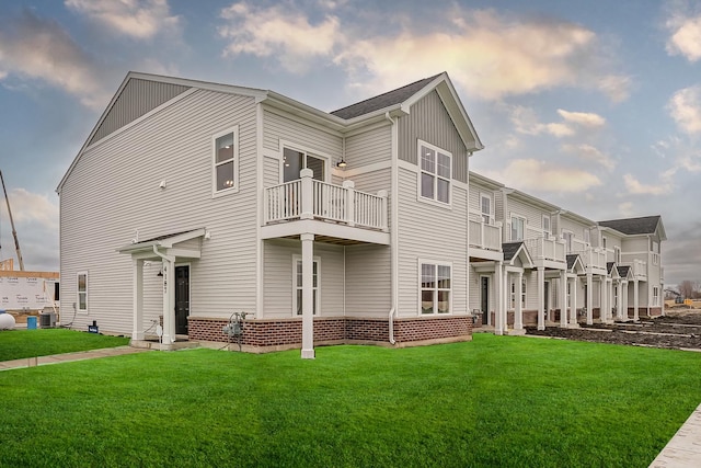 exterior space with cooling unit, a yard, and a balcony