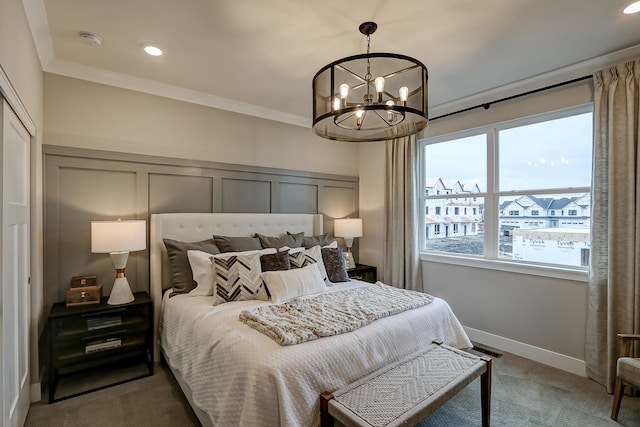 bedroom featuring an inviting chandelier, crown molding, and carpet flooring