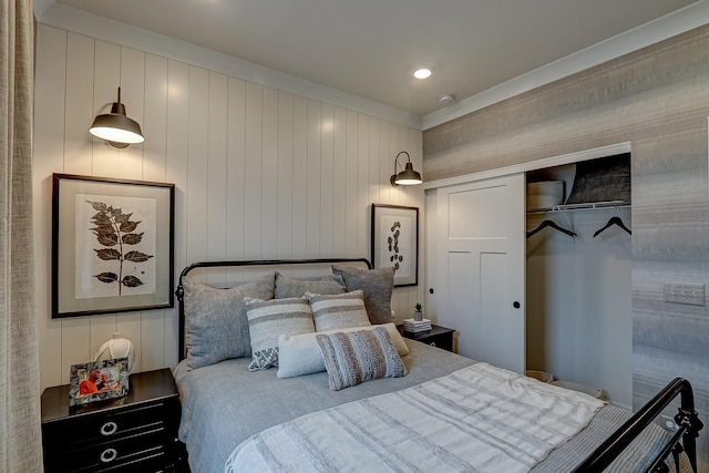 bedroom featuring wood walls