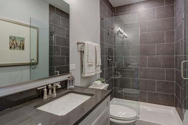 bathroom with vanity, an enclosed shower, and toilet