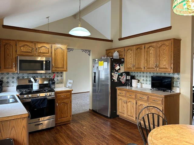 kitchen with appliances with stainless steel finishes, hanging light fixtures, beam ceiling, dark hardwood / wood-style floors, and decorative backsplash