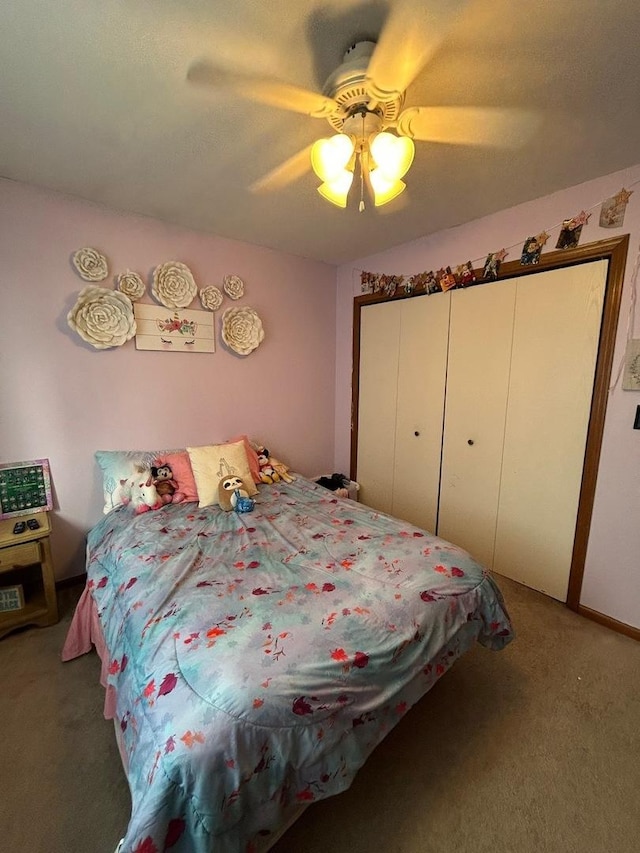 bedroom with carpet floors, ceiling fan, and a closet