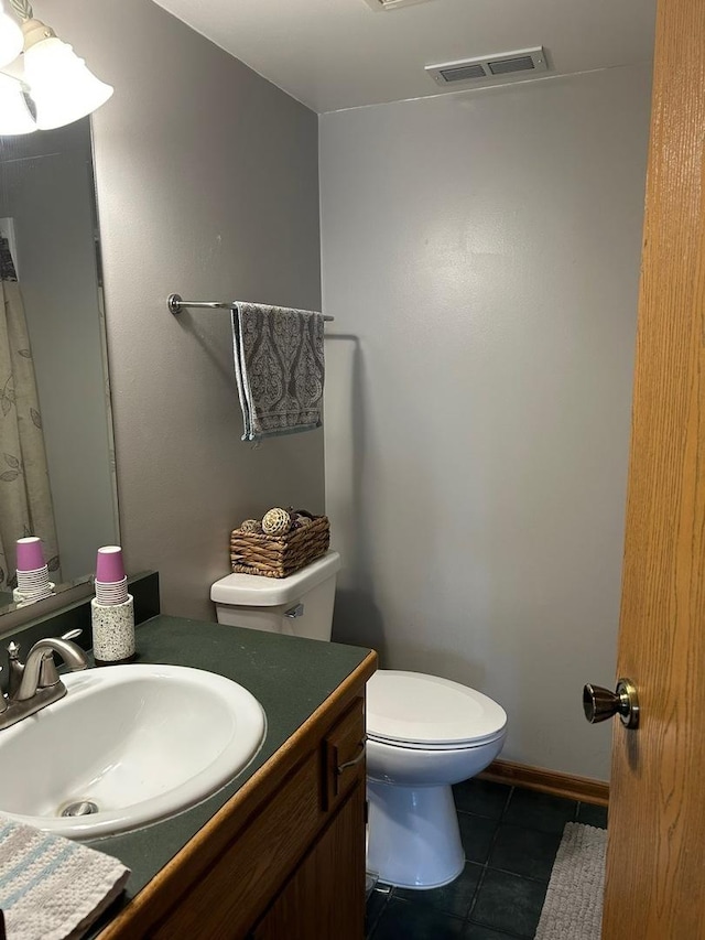 bathroom with vanity, tile patterned floors, and toilet