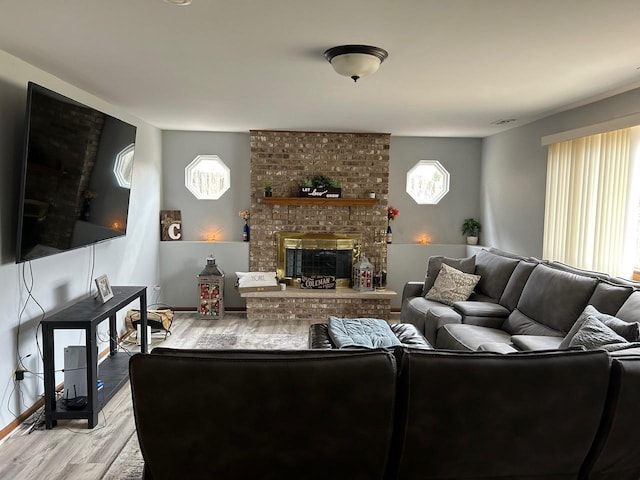 living room with a fireplace and light hardwood / wood-style flooring