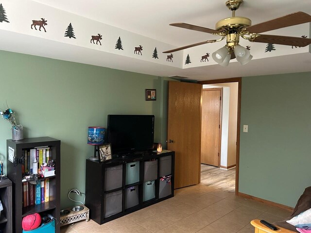 living room with light tile patterned floors and ceiling fan