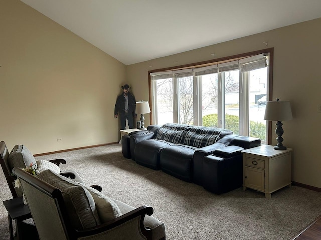 carpeted living room featuring lofted ceiling