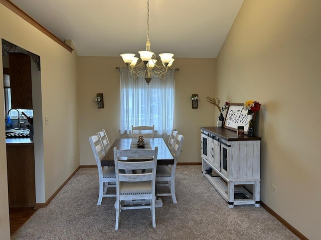 dining space with carpet flooring and a notable chandelier