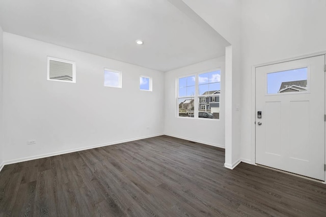 foyer entrance featuring baseboards and dark wood-style flooring