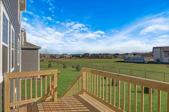 wooden terrace featuring a yard