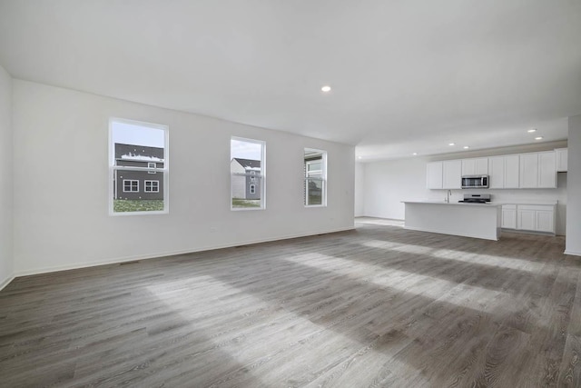 unfurnished living room featuring hardwood / wood-style flooring