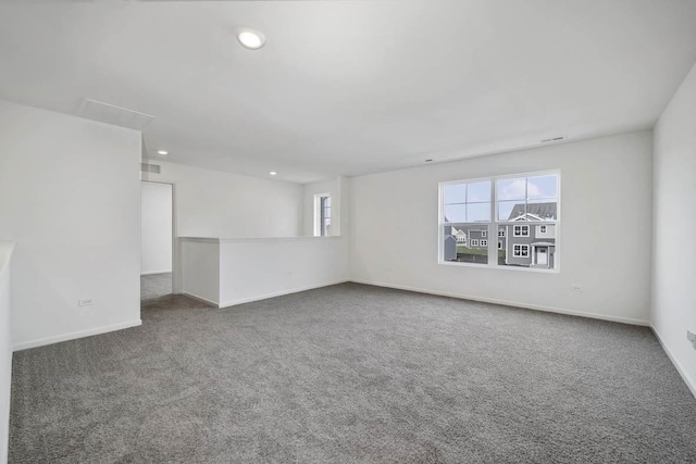 carpeted spare room featuring a wealth of natural light